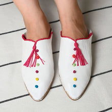Load image into Gallery viewer, White slippers with colorful embellishments and pink tassels on a striped background