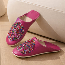 Charger l'image dans la galerie, Pair of pink slippers with colorful embellishments on a wooden floor.